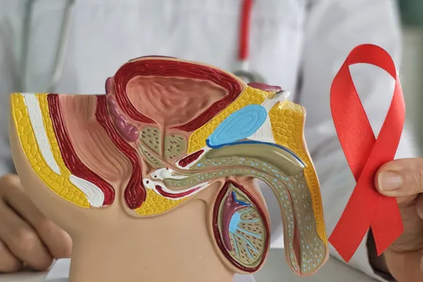 A doctor holding a HIV awareness ribbon