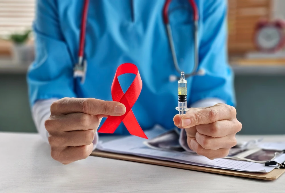 A doctor holding an HIV awareness ribbon.