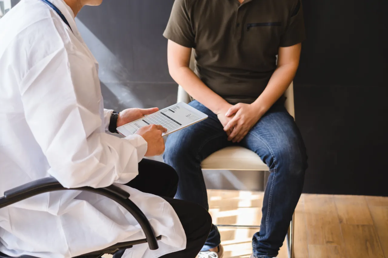 A patient discussing erectile dysfunction with a doctor