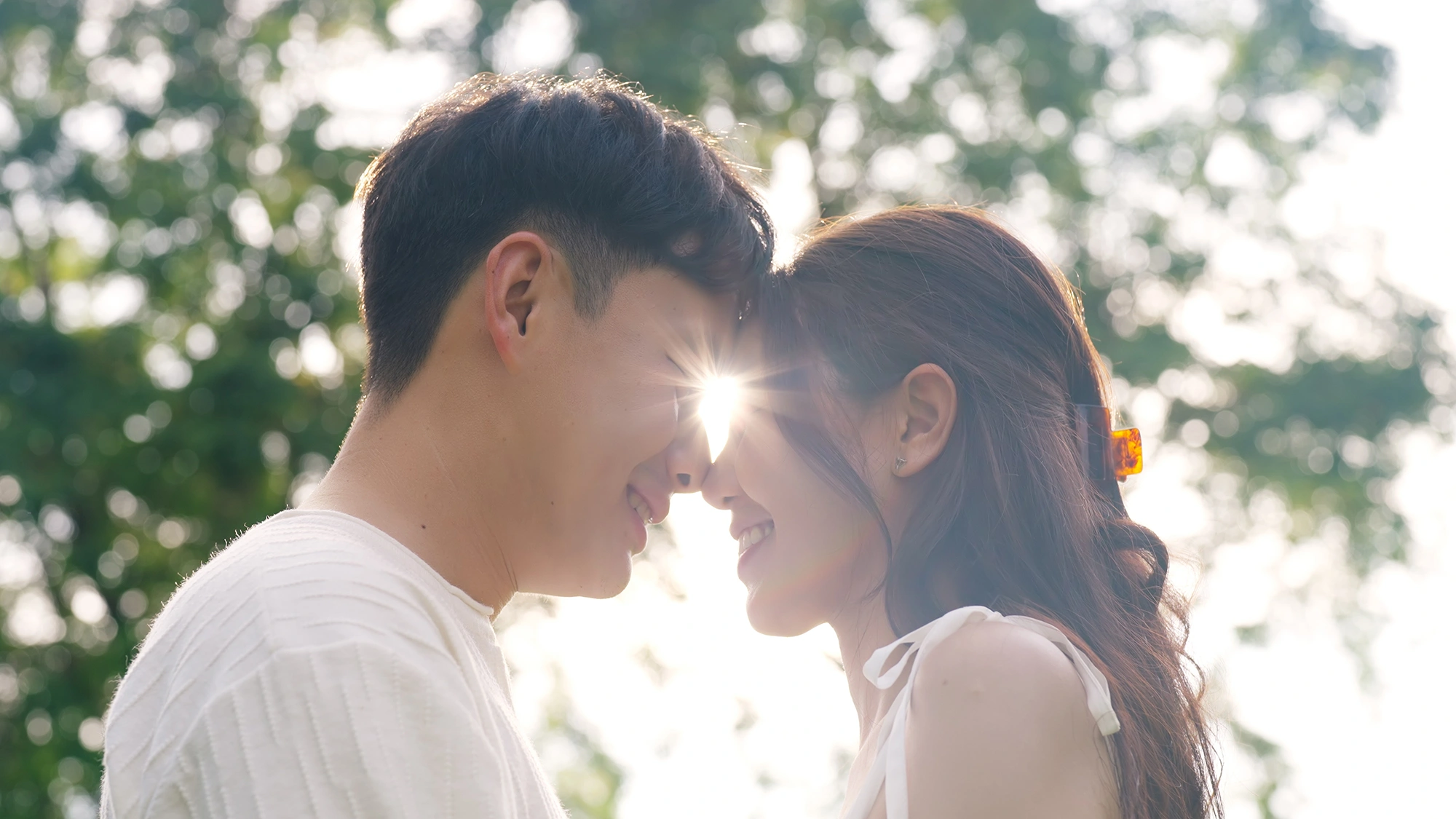 A couple standing outdoors.
