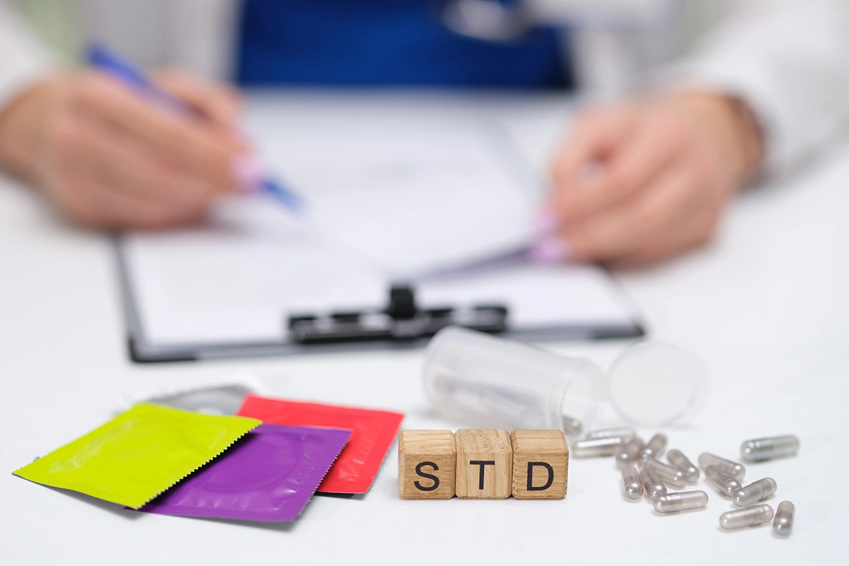 A doctor reviewing STD treatments and medication at a men’s health clinic